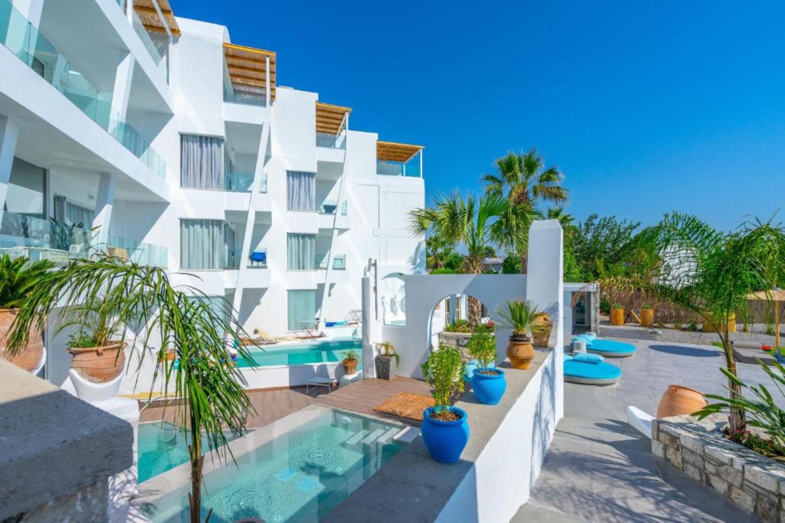 Exterior view of Kouros Home and Suites with outdoor pool in Faliraki Rhodes