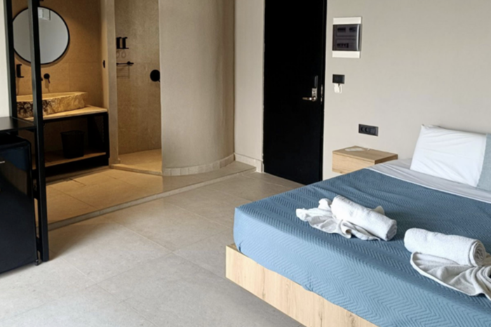 General interior view of the Double Room Premium Pool Side with a comfortable bed and modern en-suite bathroom at Kouros Home and Suites in Faliraki, Rhodes.